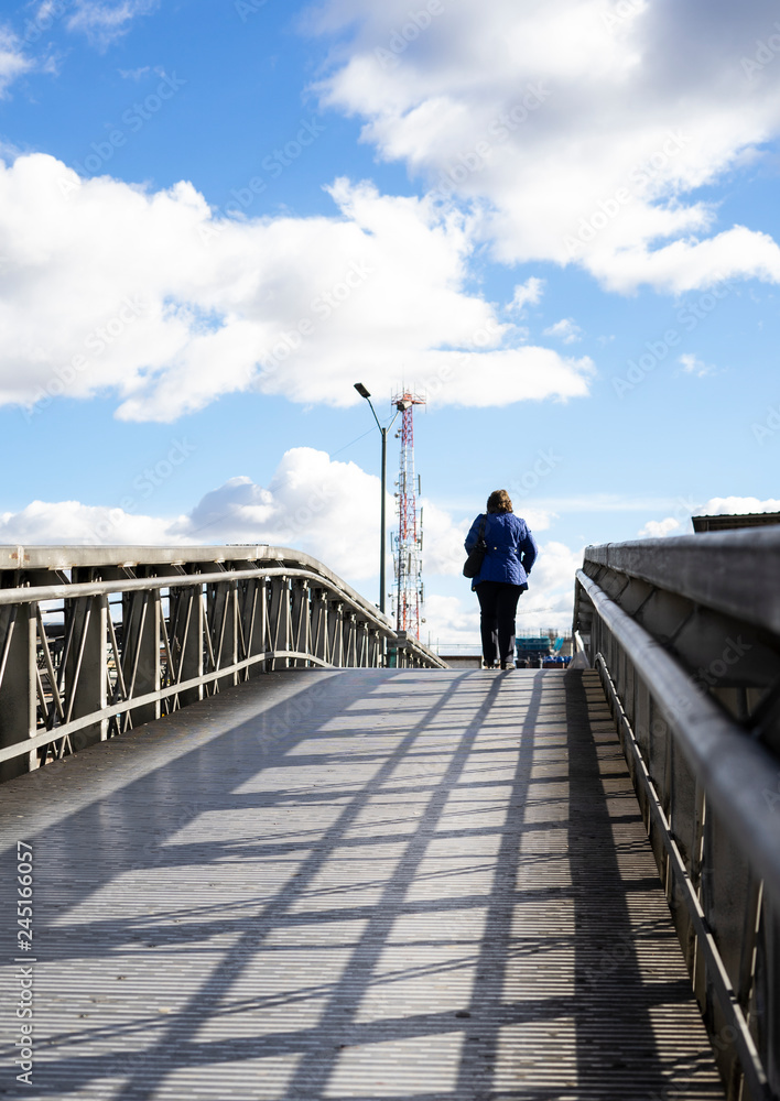 woman walking on pedestrian bridge