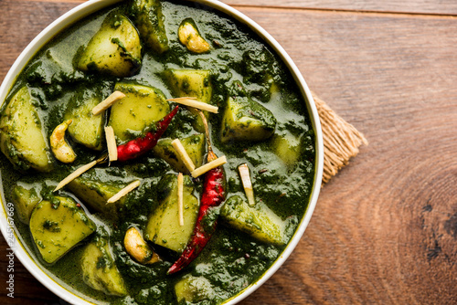 Aloo Palak sabzi or Spinach Potatoes curry served in a bowl. Popular Indian healthy recipe. Selective focus photo