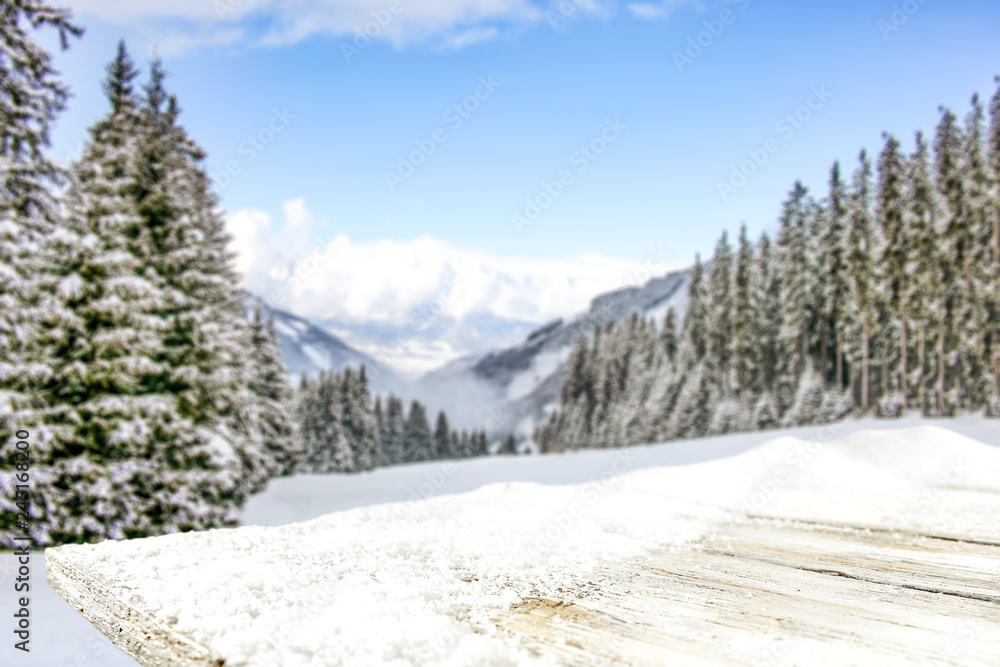 Table background of free space and winter landscape of trees and mountains. 