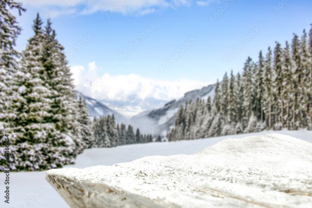 Table background of free space and winter landscape of trees and mountains. 