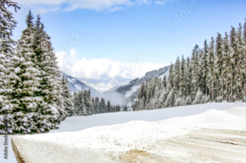 Table background of free space and winter landscape of trees and mountains. © magdal3na
