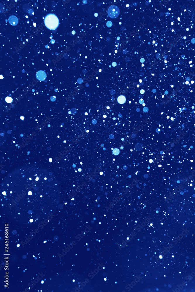 Real snow on blue background. Real snow bokeh texture on dark blue background. Design element that can be used on its own or as an overlay. Real snow on blue background. Real snow bokeh texture on dark blue background. Design element that can be used on its own or as an overlay.