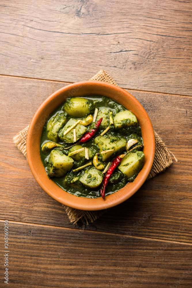 Aloo Palak sabzi or Spinach Potatoes curry served in a bowl. Popular Indian healthy recipe. Selective focus Aloo Palak sabzi or Spinach Potatoes curry served in a bowl. Popular Indian healthy recipe. Selective focus