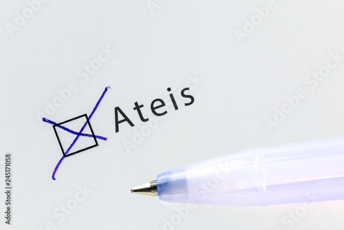 Ateis - checkbox with a cross on white paper with blue pen. Checklist concept