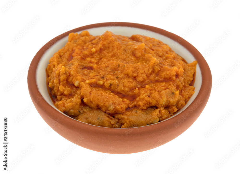 Small bowl of ricotta cheese and tomato pesto on a white background Small bowl of ricotta cheese and tomato pesto on a white background