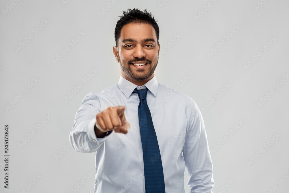 business, office worker and people concept - smiling indian businessman in shirt with tie over grey background business, office worker and people concept - smiling indian businessman in shirt with tie over grey background