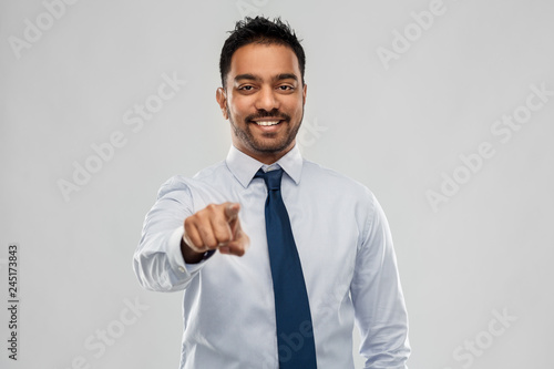 business, office worker and people concept - smiling indian businessman in shirt with tie over grey background © Syda Productions