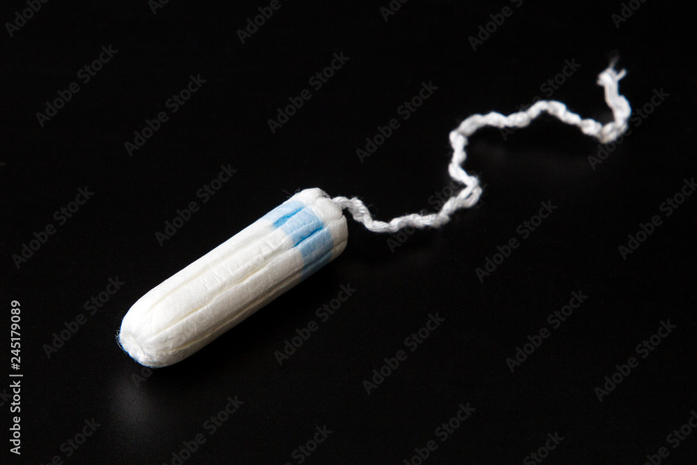 Female tampon on black background Female tampon on black background