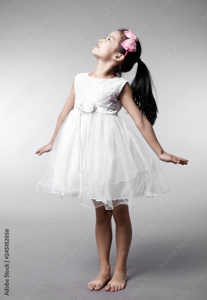 Fototapeta premium Cute Asian Chinese little girl indoors against white background