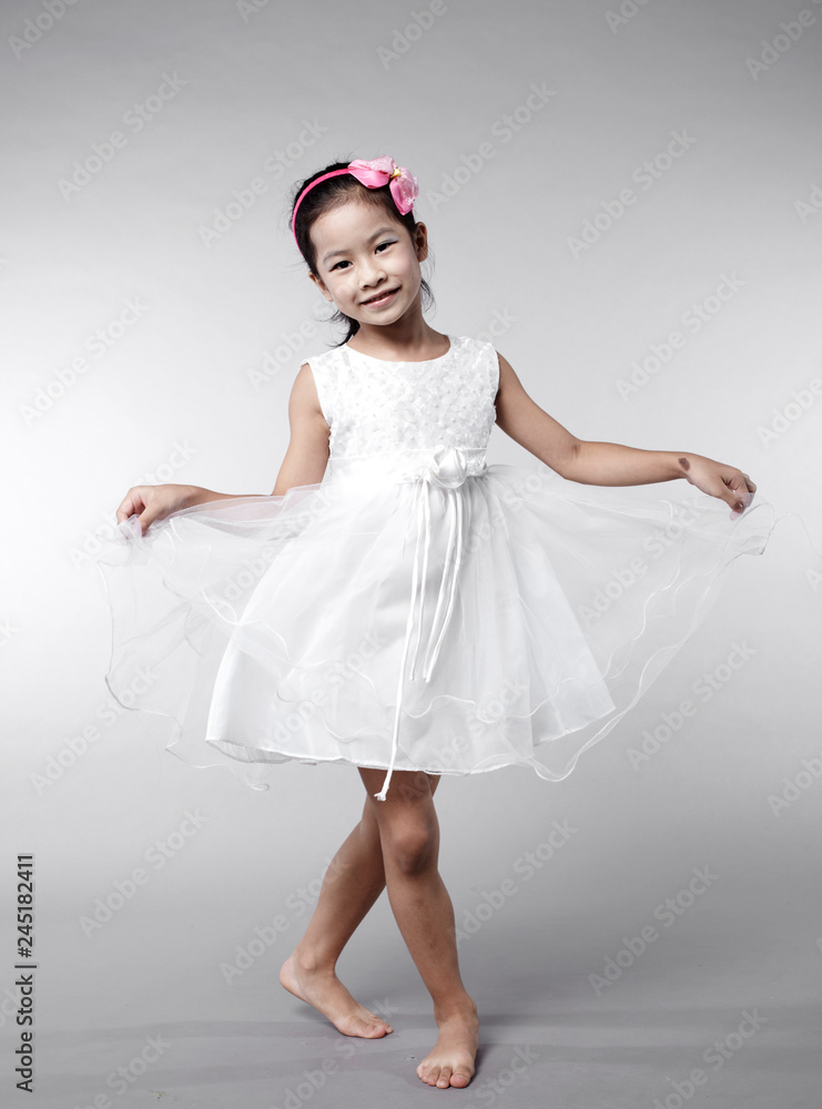 Naklejka premium Cute Asian Chinese little girl indoors against white background