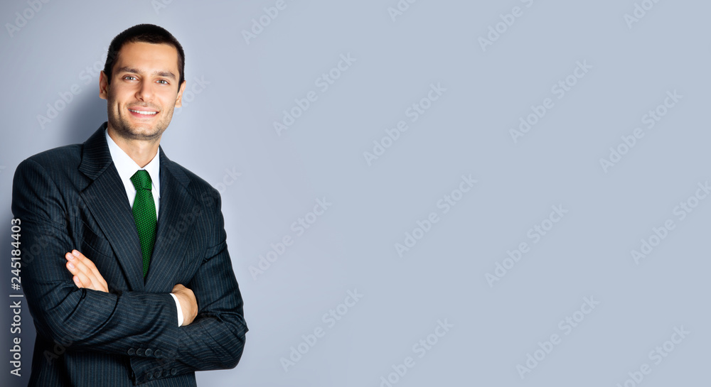 Happy businessman with crossed arms, on grey Happy businessman with crossed arms, on grey