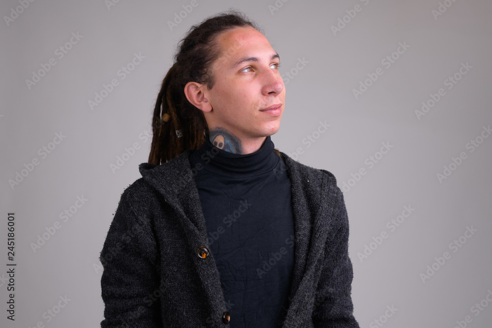 Fototapeta premium Portrait of young handsome man with dreadlocks thinking