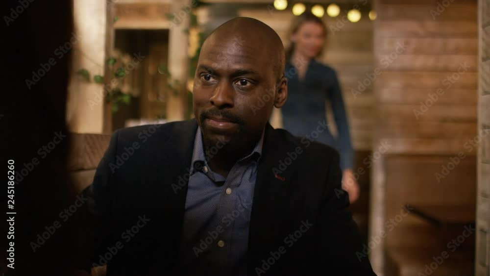 Handsome black male talking with his date in a coffee shop