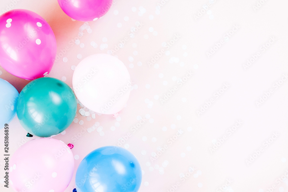 Colorful balloons on pastel color background. Festive or birthday party concept. Flat lay, top view.