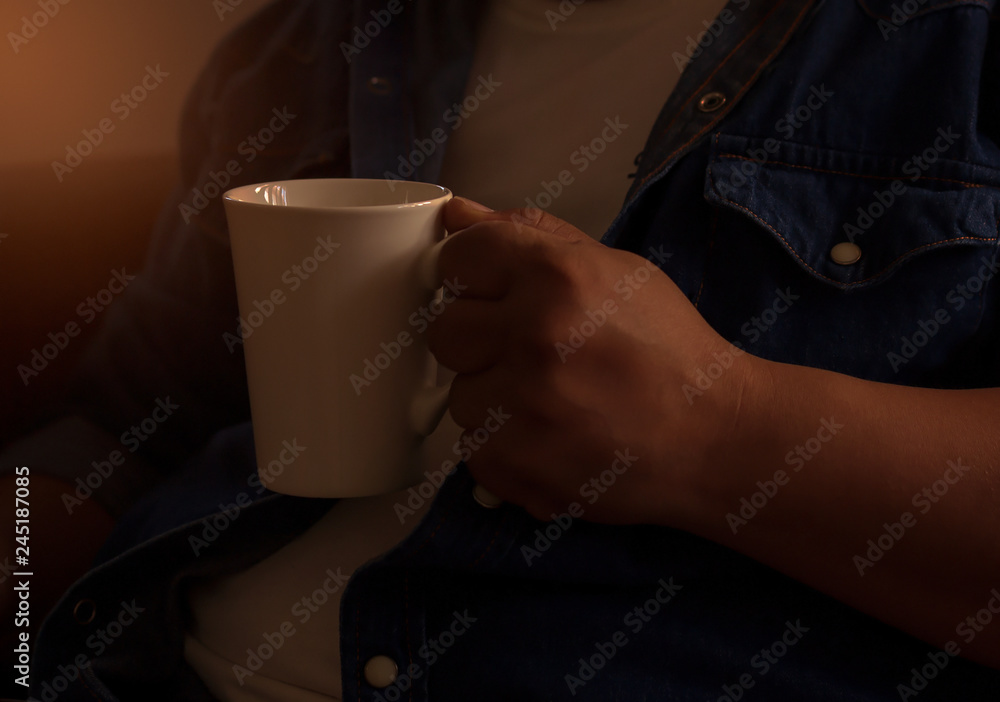 People are holding a white coffee mug People are holding a white coffee mug