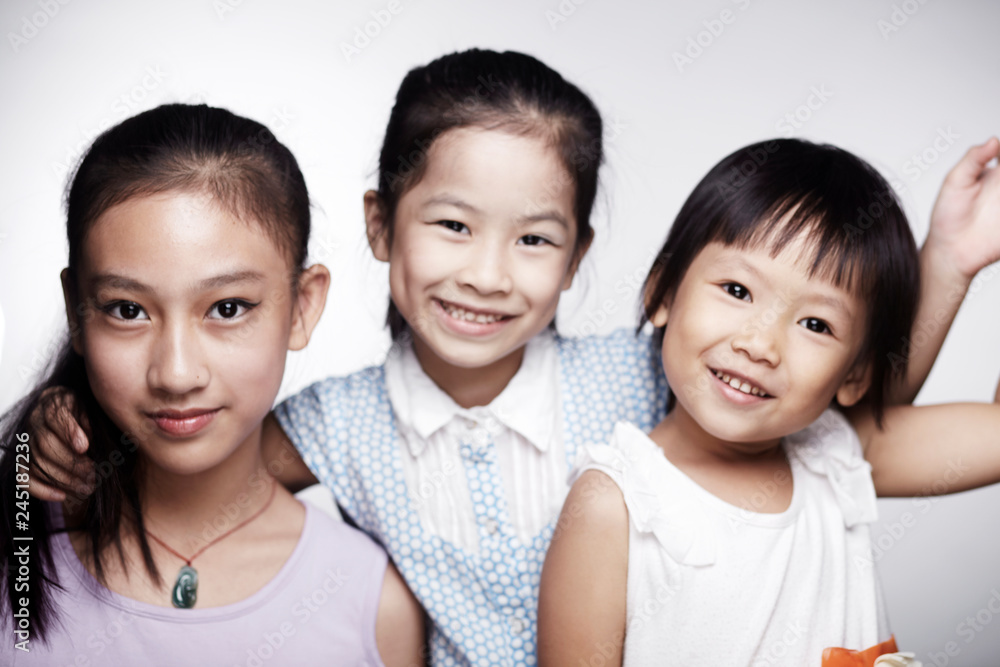 Three beautiful cute Asian little girls happily interacting indoors Three beautiful cute Asian little girls happily interacting indoors