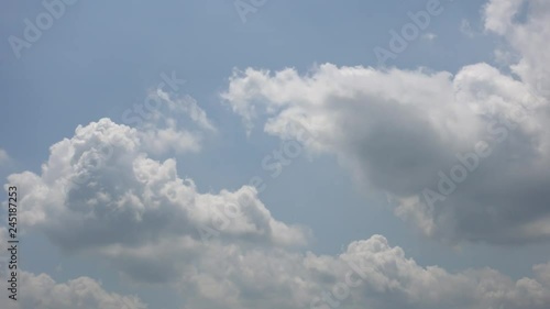 White Puffy Clouds With Rays Of Sunshine Timelapse photo