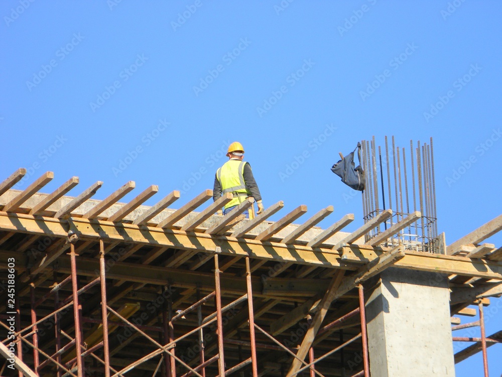 Construction worker on top of a residential building under construction, Tirana, Albania