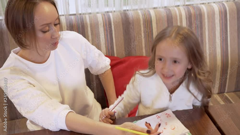 Cute Young Woman And A Little Beautiful Daughter Tell Each Other Something Cute Young Woman And A Little Beautiful Daughter Tell Each Other Something