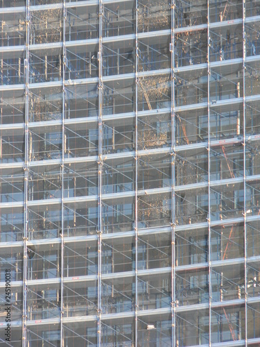 Close up view of scaffolding and safety net covering building under construction, Tirana, Albania