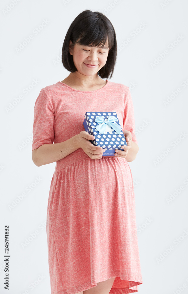 Pregnant woman waiting for a desired baby with gift ,White background in studio Pregnant woman waiting for a desired baby with gift ,White background in studio