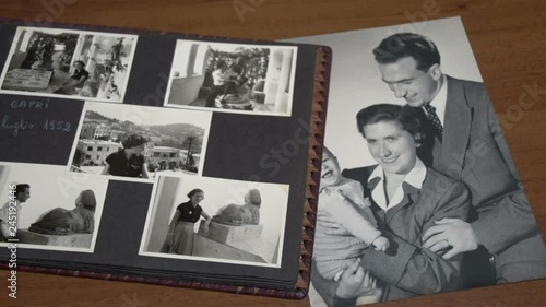 Slow motion of browsing vintage album with a lot of photos of mother, father and son FDV