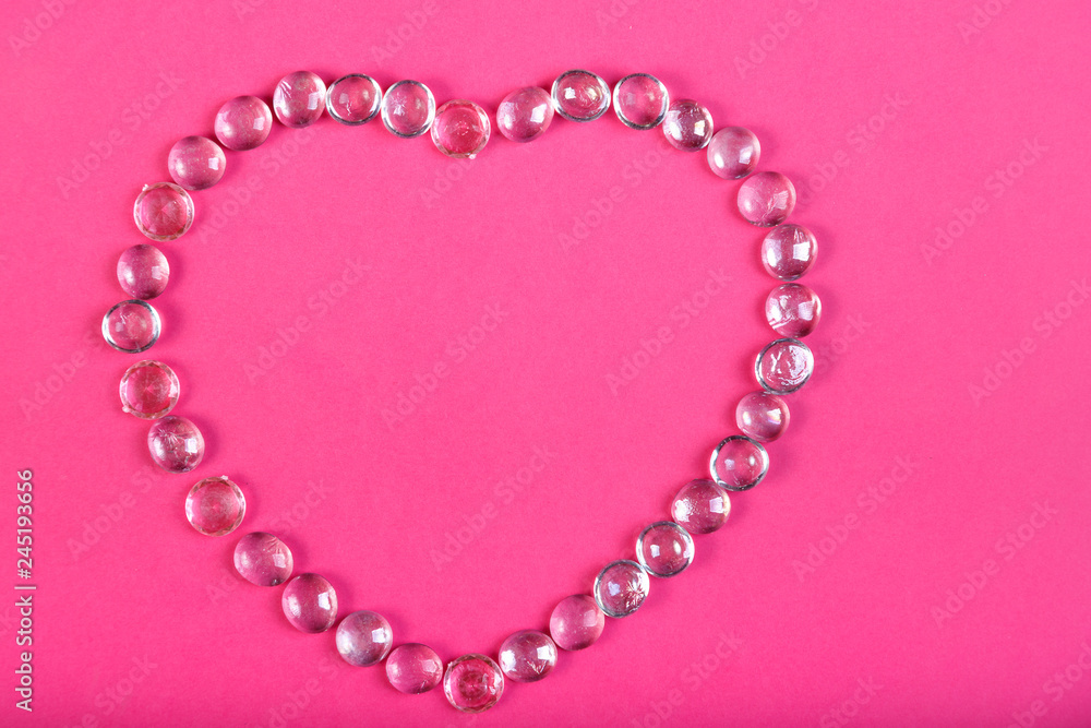 Obraz premium Beaded heart on a pink background Horizontal