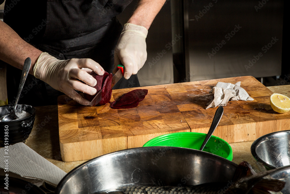 process of cutting beetroot on wooden cutting board