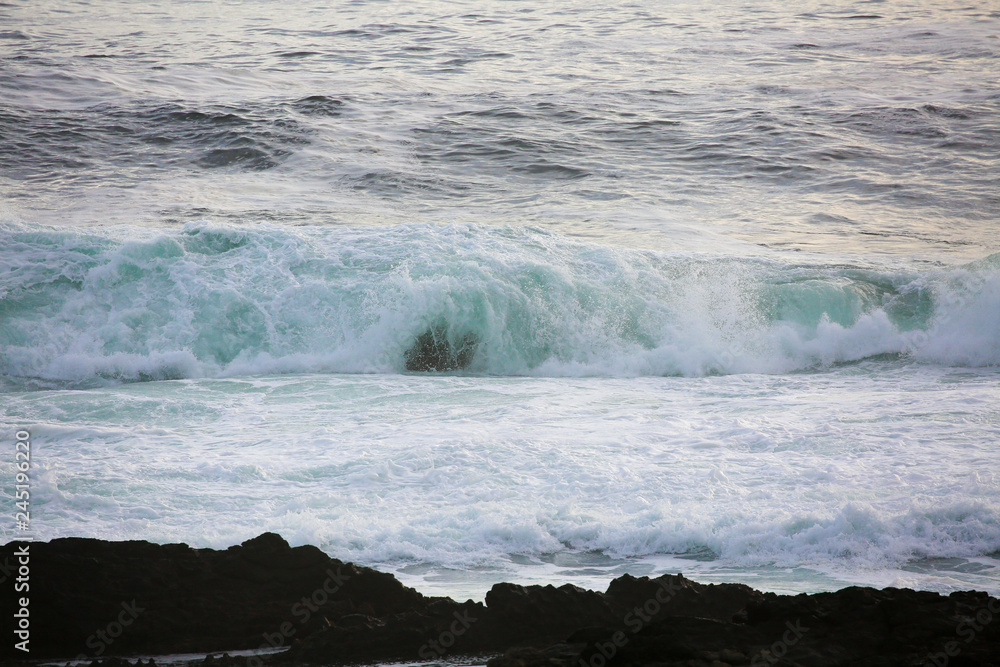waves breaking on beach waves breaking on beach