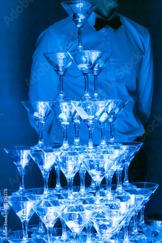 Pyramid of champagne with liquid nitrogen. Colorful lights