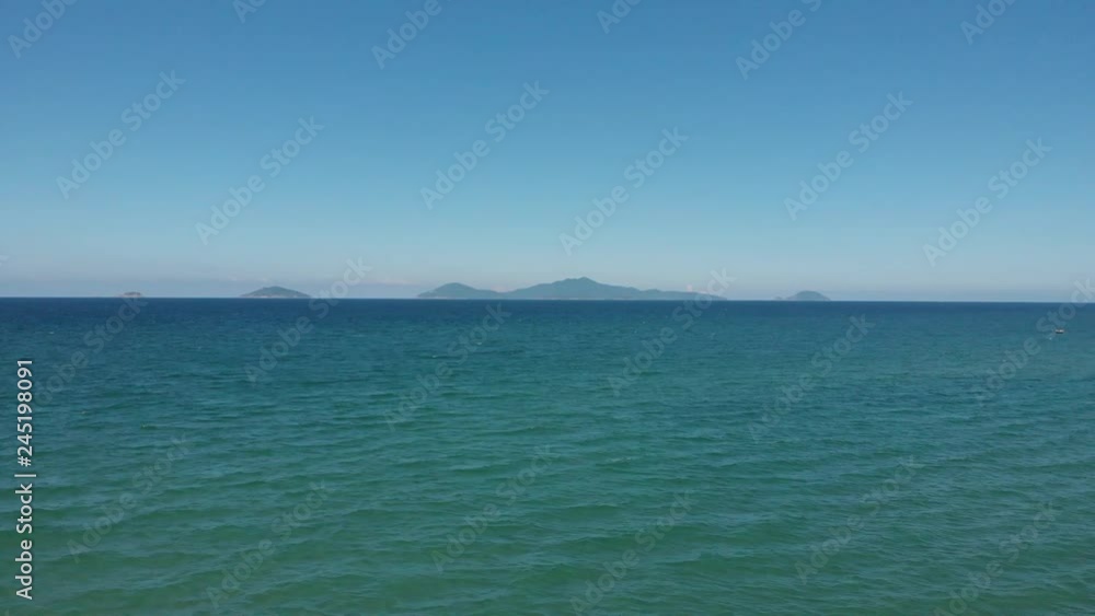 Aerial Shot - flying across the ocean to a mountain Aerial Shot - flying across the ocean to a mountain