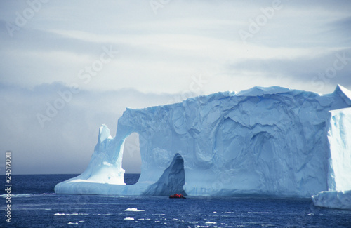 Antarctica; exploring a hugh iceberg photo