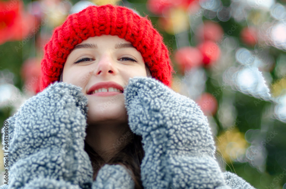Outdoor portrait of elegant brunette woman wearing stylish red cap and warm coat. Space for text Outdoor portrait of elegant brunette woman wearing stylish red cap and warm coat. Space for text