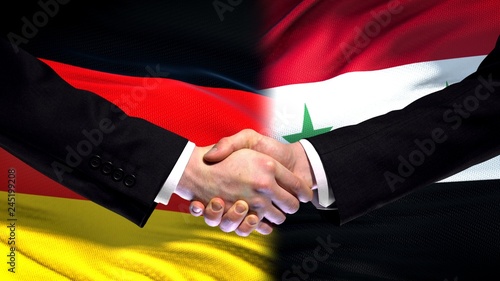 Germany and Syria handshake, international friendship relations, flag background