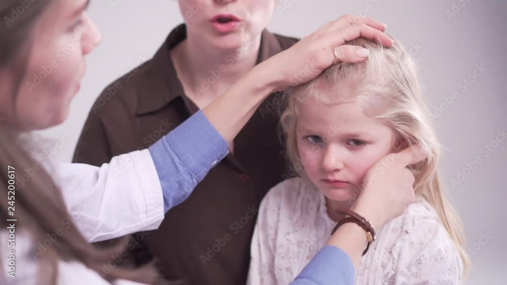 doctor is palpating lymph node on the neck of 5 years old girl, medical checkup doctor is palpating lymph node on the neck of 5 years old girl, medical checkup