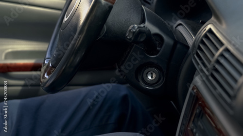 Man sitting inside modern car, transmission steering wheel and dashboard closeup
