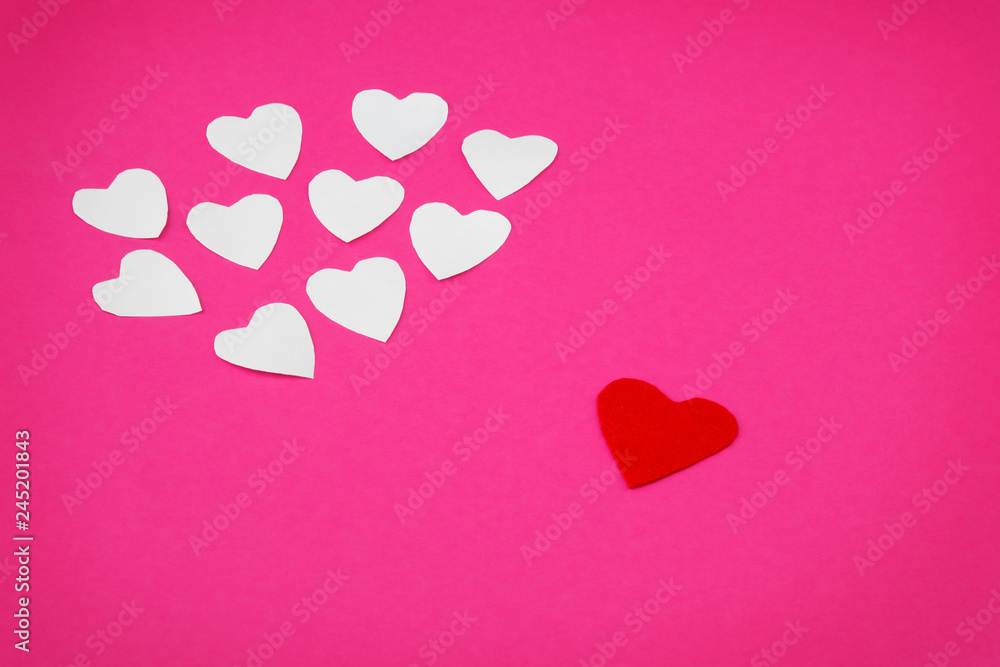 White and red paper forms of  heart on a pink background
