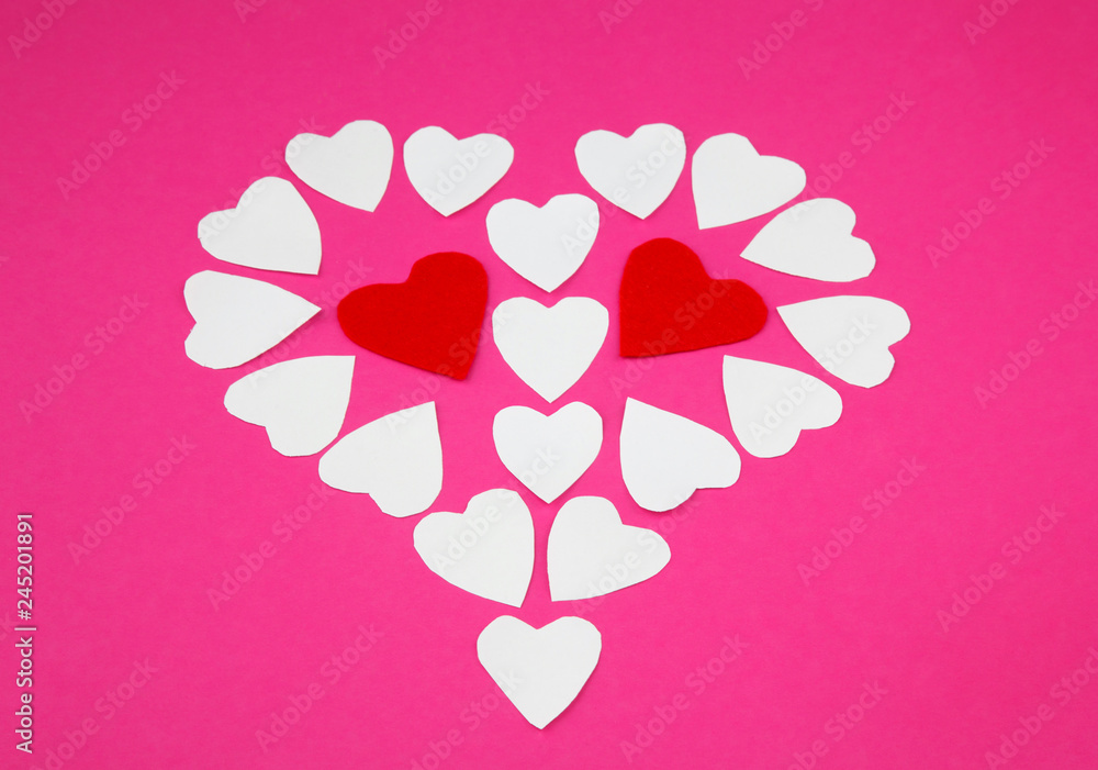 White and red paper forms of  heart on a pink background as a symbol