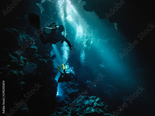 Wallpaper Mural Male scuba divers swimming in red sea Torontodigital.ca