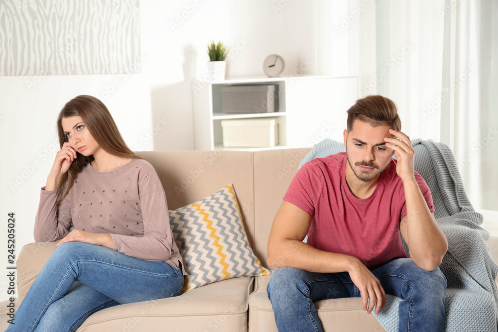 Fototapeta premium Young couple with relationship problems in living room