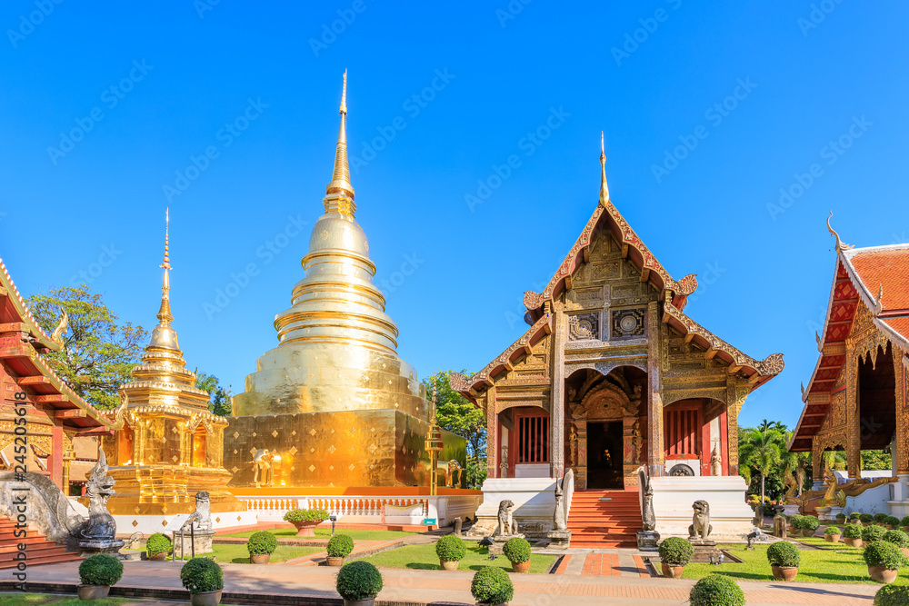 Fototapeta premium Chapel and golden pagoda at Wat Phra Singh Woramahawihan in Chiang Mai, North of Thailand