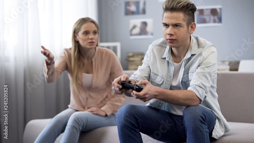 Upset sister shouting at playing games brother, lack of life communication