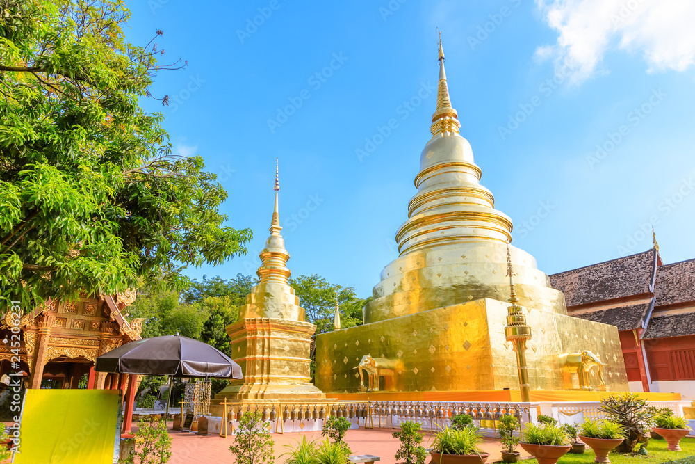 Naklejka premium Chapel and golden pagoda at Wat Phra Singh Woramahawihan in Chiang Mai, North of Thailand