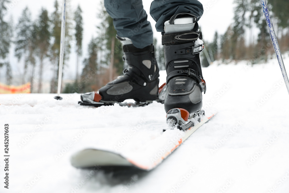 Skier on slope at resort, closeup. Winter vacation Skier on slope at resort, closeup. Winter vacation