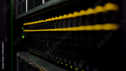Data storage illuminated with led, networking connection, server racks closeup