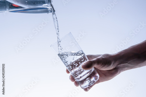 Filling up the water glass from water filter photo