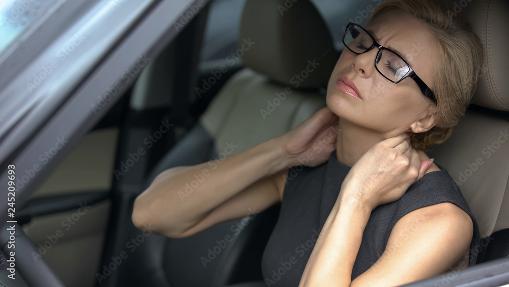 Tired business lady in car feeling strong neck pain, nerve inflammation, health Tired business lady in car feeling strong neck pain, nerve inflammation, health