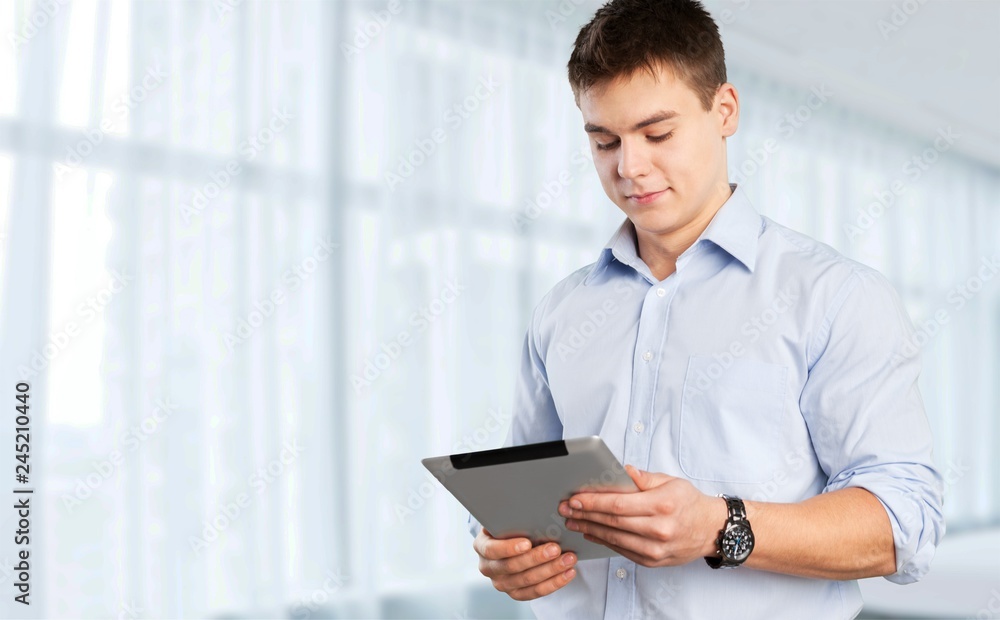 Young male teacher standing with book Young male teacher standing with book