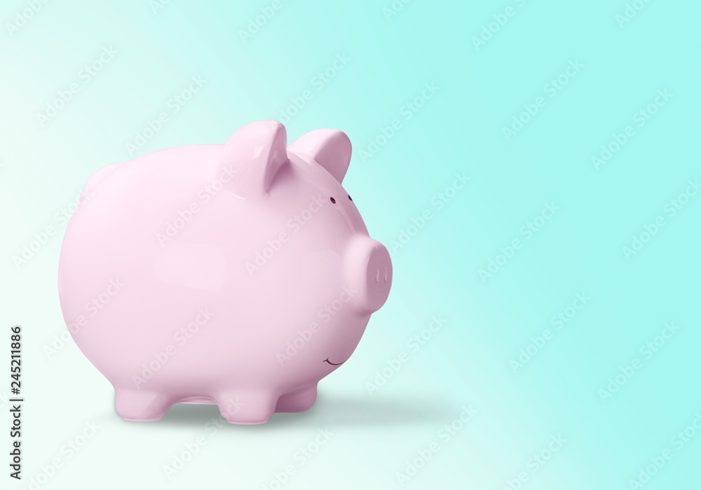 Pink ceramic piggy bank with copy space alongside in a