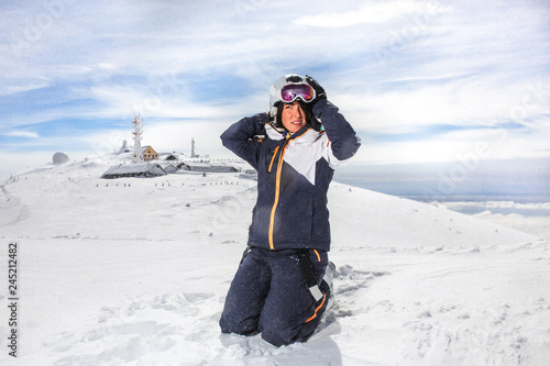 woman smile on top of a snow mountain